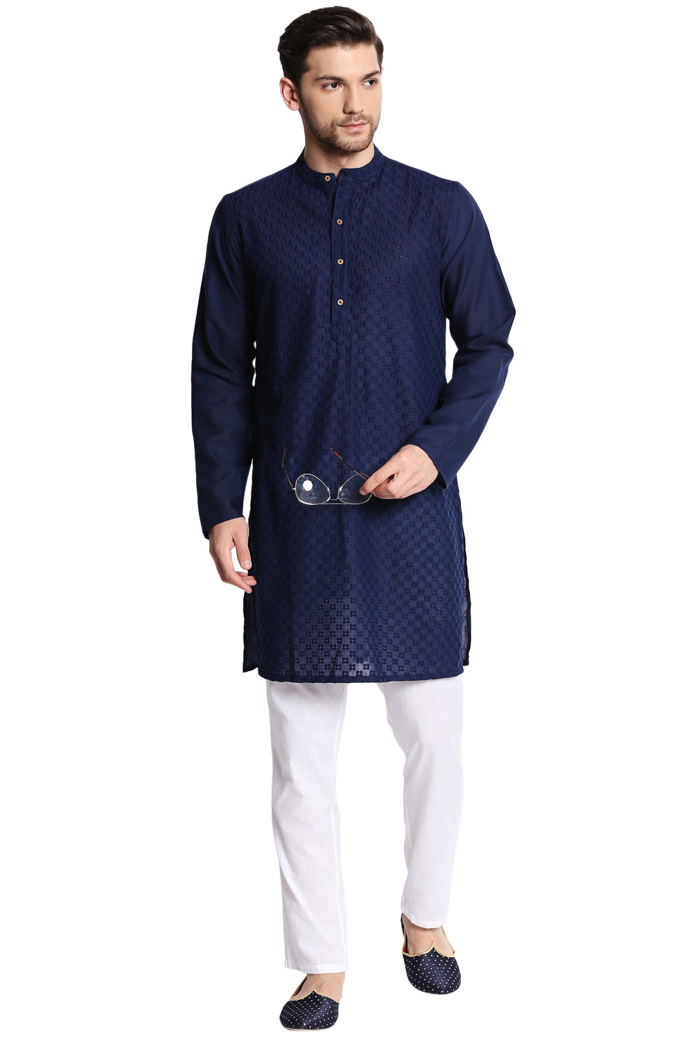 Man wearing a navy kurta with white pants on a white background