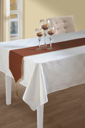 In-Sattva brown solid cotton table runner with fringe styled on a white dining table with wine glasses
