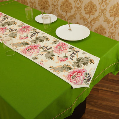 Cream In-Sattva bohemian floral print table runner styled with white place settings on a green table