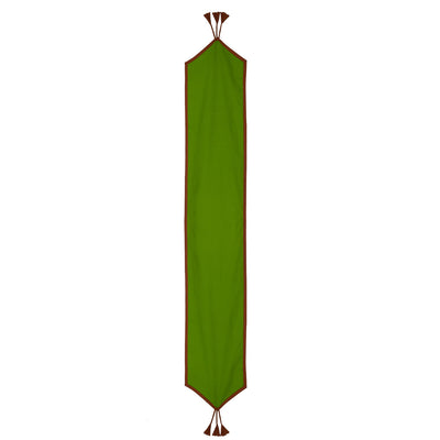 Full view of the In-Sattva green solid cotton table runner with brown trim and tassel fringe