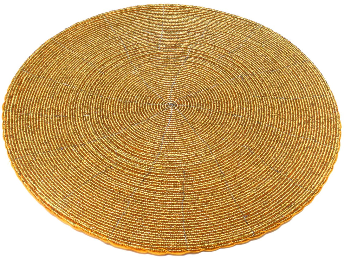 Angled view of an In-Sattva gold handmade glass beaded round dining placemat