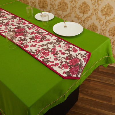 Magenta In-Sattva bohemian floral print table runner styled with white place settings on a green table