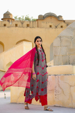 Woman displaying a In-Sattva magenta dupatta with gold block print, decorative border and tassels