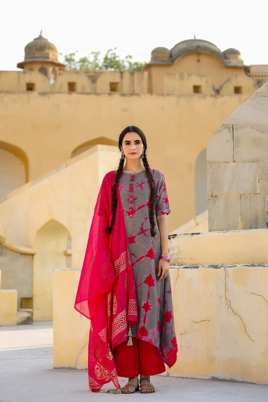 Full-length front view of a woman styling a In-Sattva magenta dupatta with gold block print and tassels
