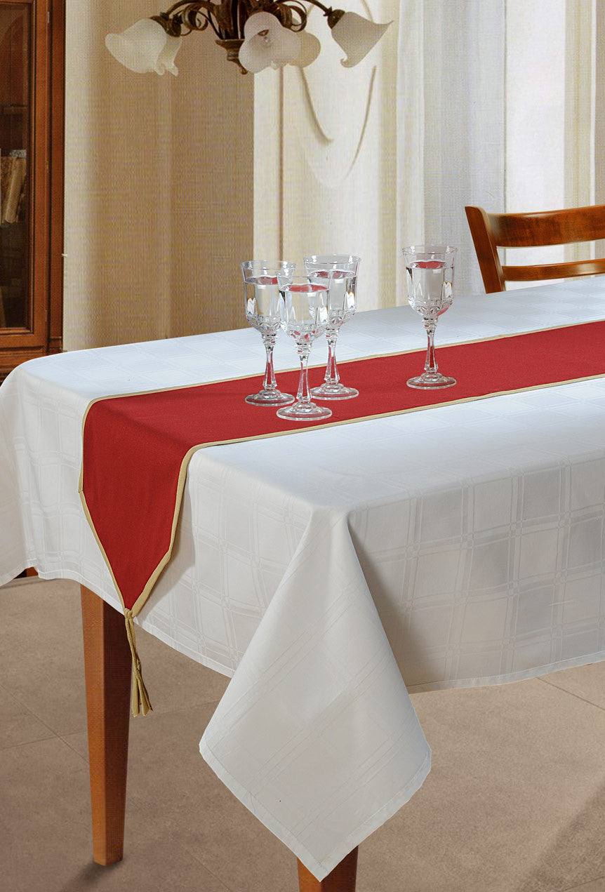 In-Sattva maroon solid cotton table runner with gold trim styled on a white dining table with glassware