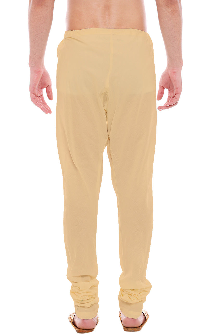 Back view of In-Sattva men's beige art silk churidar pants, showing the tapered full-length fit and ankle gathers from the back.