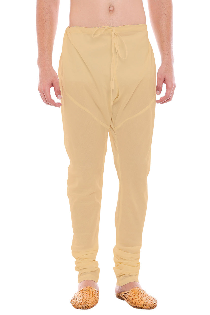 Front view of In-Sattva men's beige art silk churidar pants, showing the drawstring waist, tapered legs and ankle gathers.