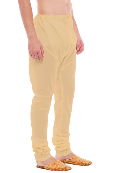 Left profile view of In-Sattva men's beige art silk churidar pants, showing the smooth art silk sheen and gathered ankle fit.