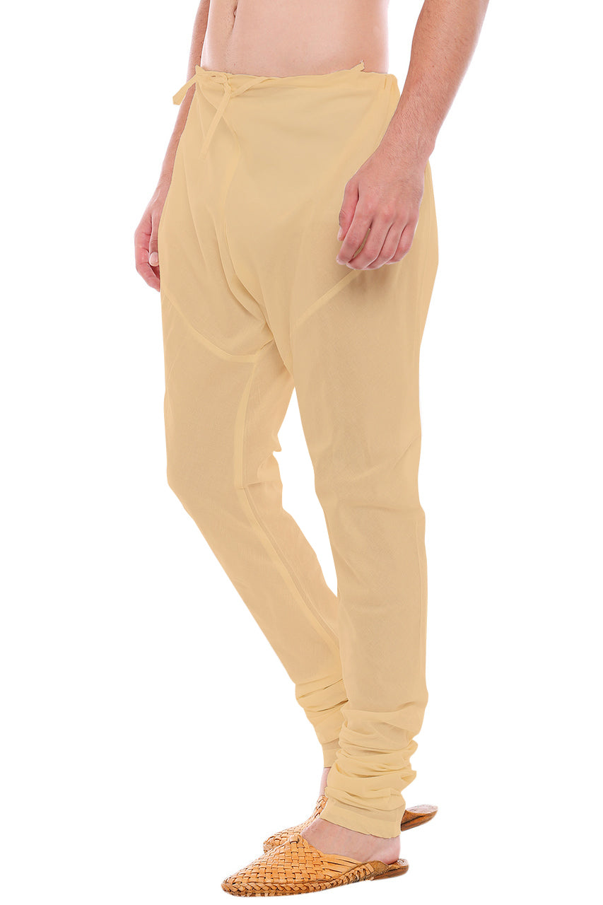 Right profile view of In-Sattva men's beige art silk churidar pants, showing the smooth art silk sheen and gathered ankle fit.