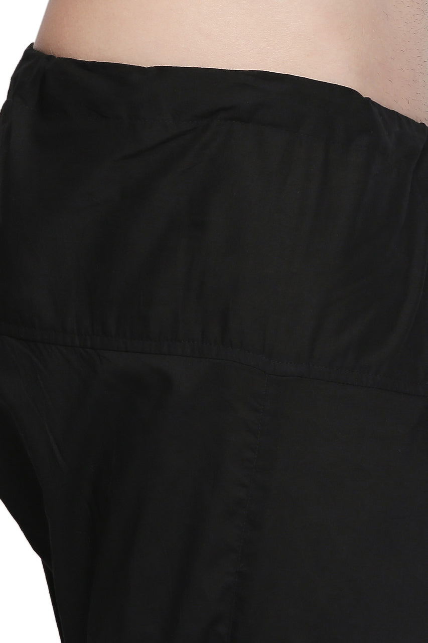 Close-up of the elastic drawstring waistband and cotton texture on In-Sattva men's black cotton baggy salwar yoga pants.