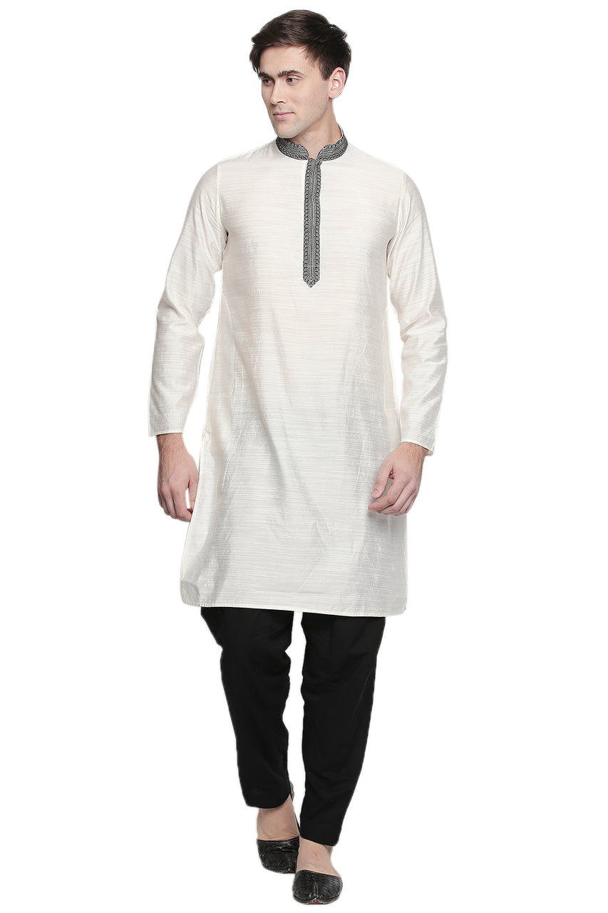 Full-length front view of In-Sattva men's black cotton baggy salwar yoga pants, showing the roomy hips and tapered ankles.