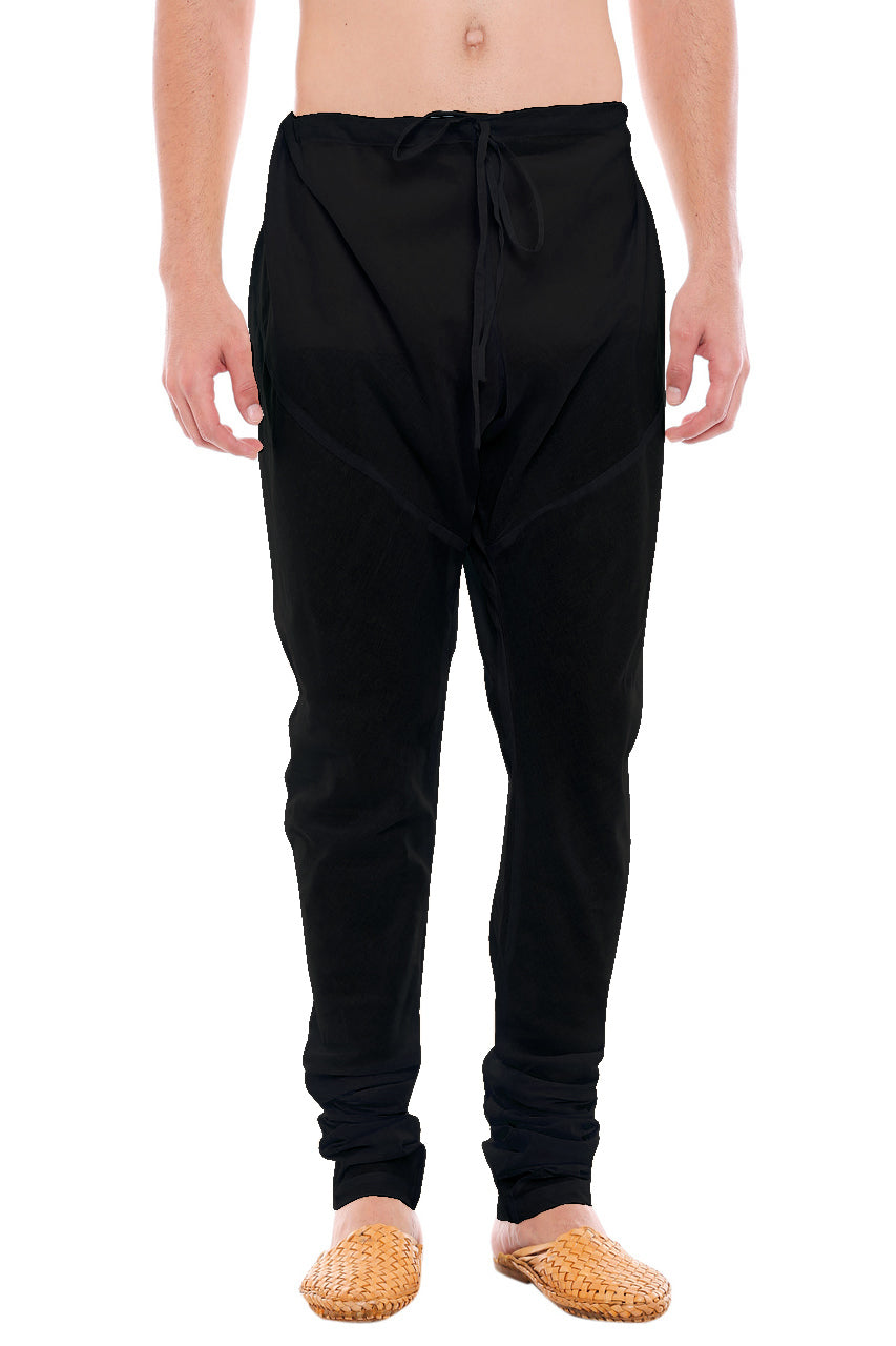 Front view of In-Sattva men's black cotton churidar pants, showing the drawstring waist, tapered legs and ankle gathers.