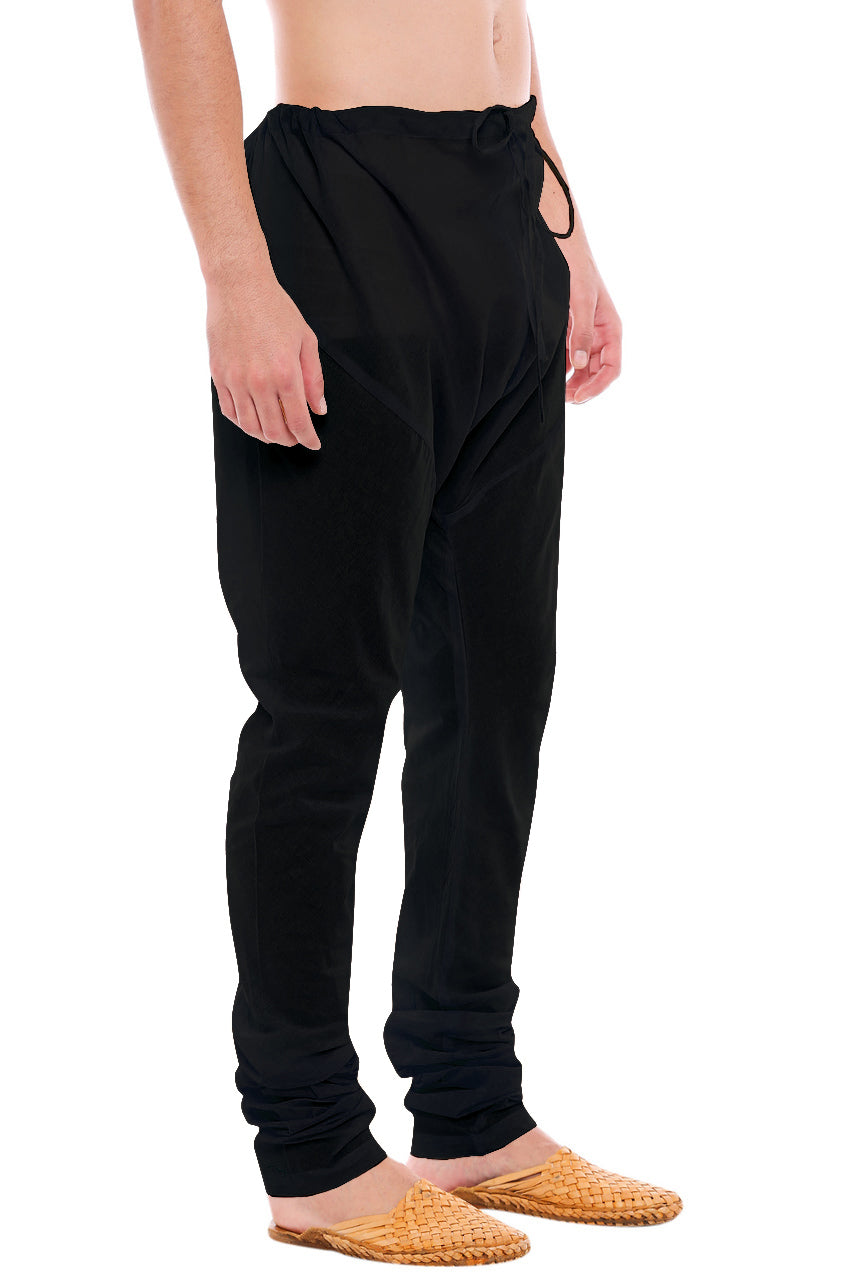 Right profile view of In-Sattva men's black cotton churidar pants, showing the smooth cotton profile and gathered ankle fit.