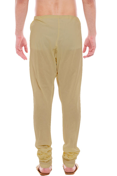 Back view of In-Sattva men's brown art silk churidar pants, showing the tapered full-length fit and ankle gathers from the back.