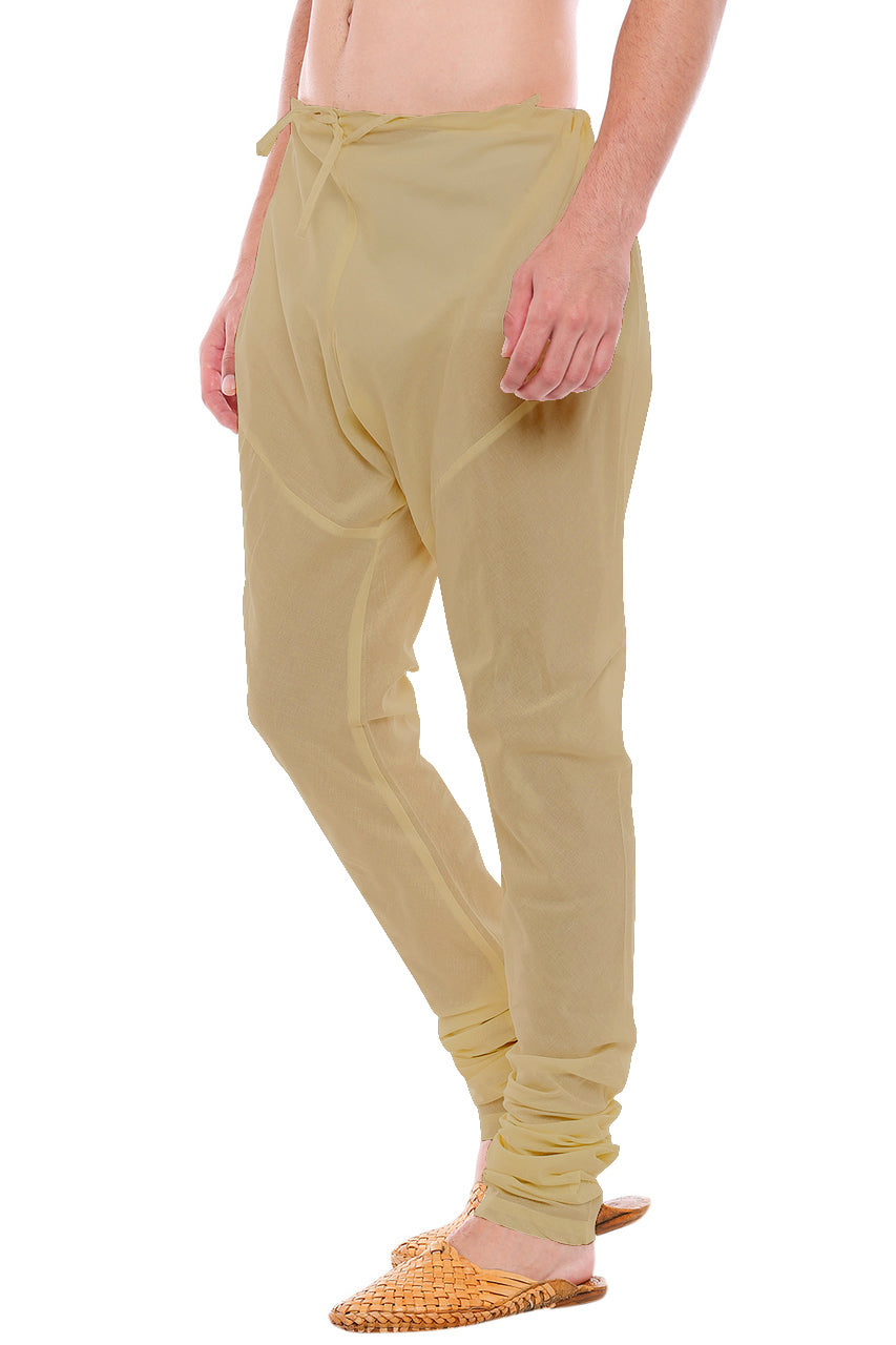 Left profile view of In-Sattva men's brown art silk churidar pants, showing the smooth art silk sheen and gathered ankle fit.