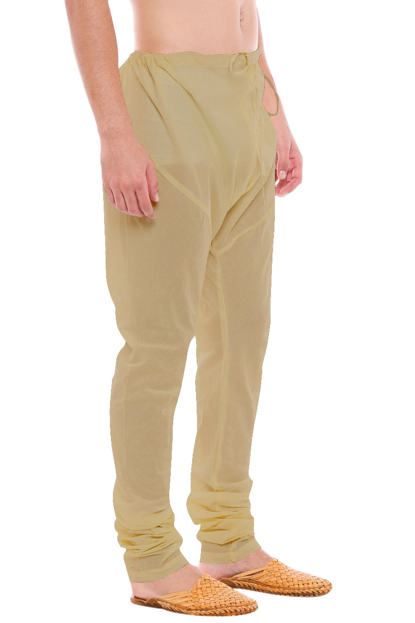 Right profile view of In-Sattva men's brown art silk churidar pants, showing the smooth art silk sheen and gathered ankle fit.