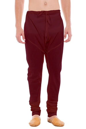 Front view of In-Sattva men's burgundy art silk churidar pants, showing the drawstring waist, tapered legs and ankle gathers.