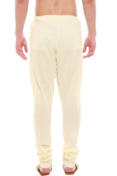 Back view of In-Sattva men's cream art silk churidar pants, showing the tapered full-length fit and ankle gathers from the back.