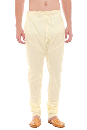 Front view of In-Sattva men's cream art silk churidar pants, showing the drawstring waist, tapered legs and ankle gathers.
