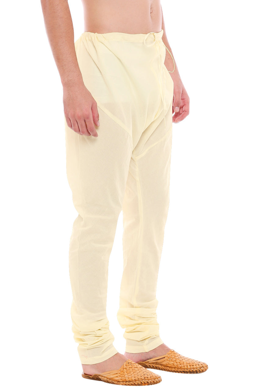 Left profile view of In-Sattva men's cream art silk churidar pants, showing the smooth art silk sheen and gathered ankle fit.