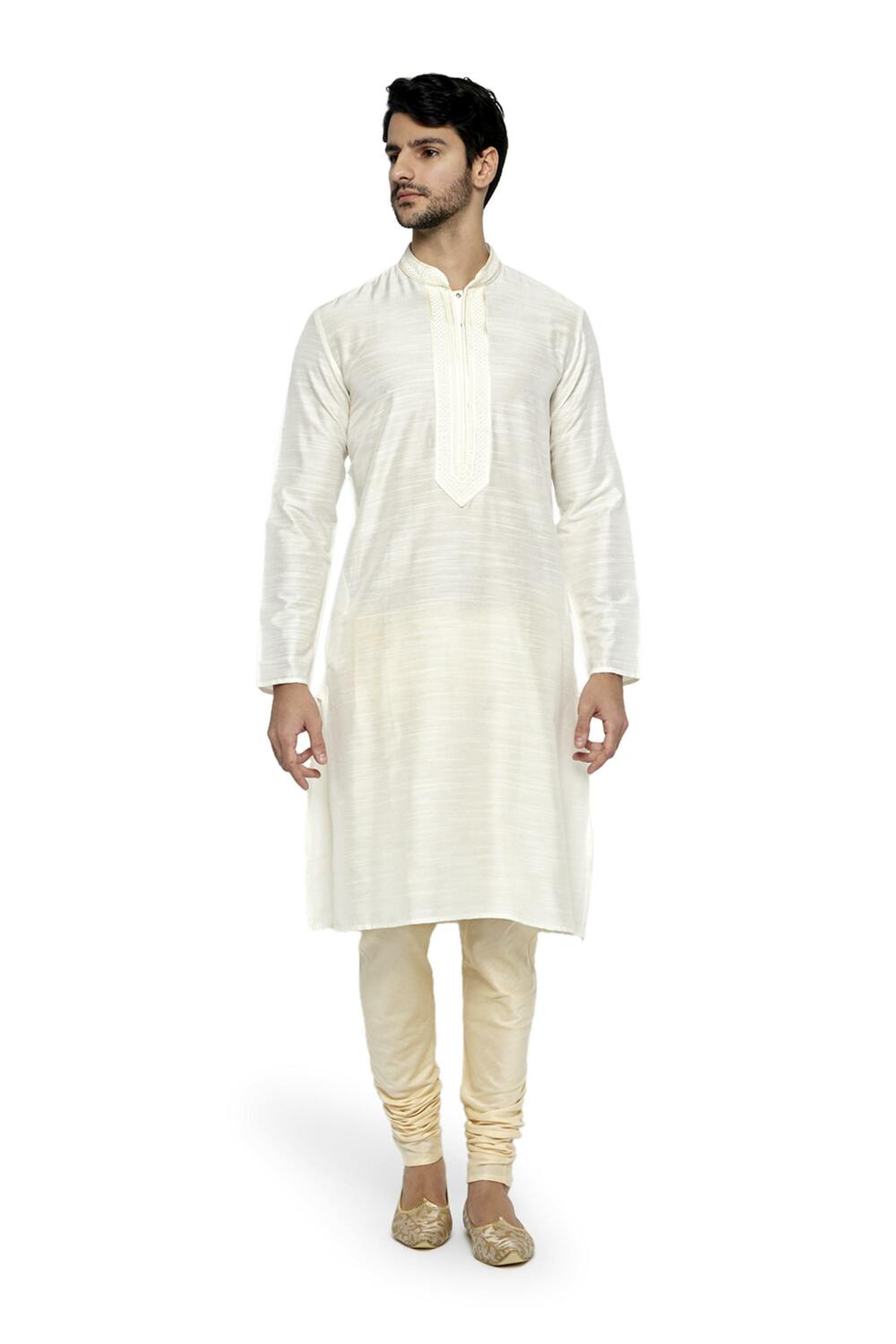 In-Sattva men's cream art silk churidar pants styled with a kurta, showing the coordinated color and gathered ankle fit.