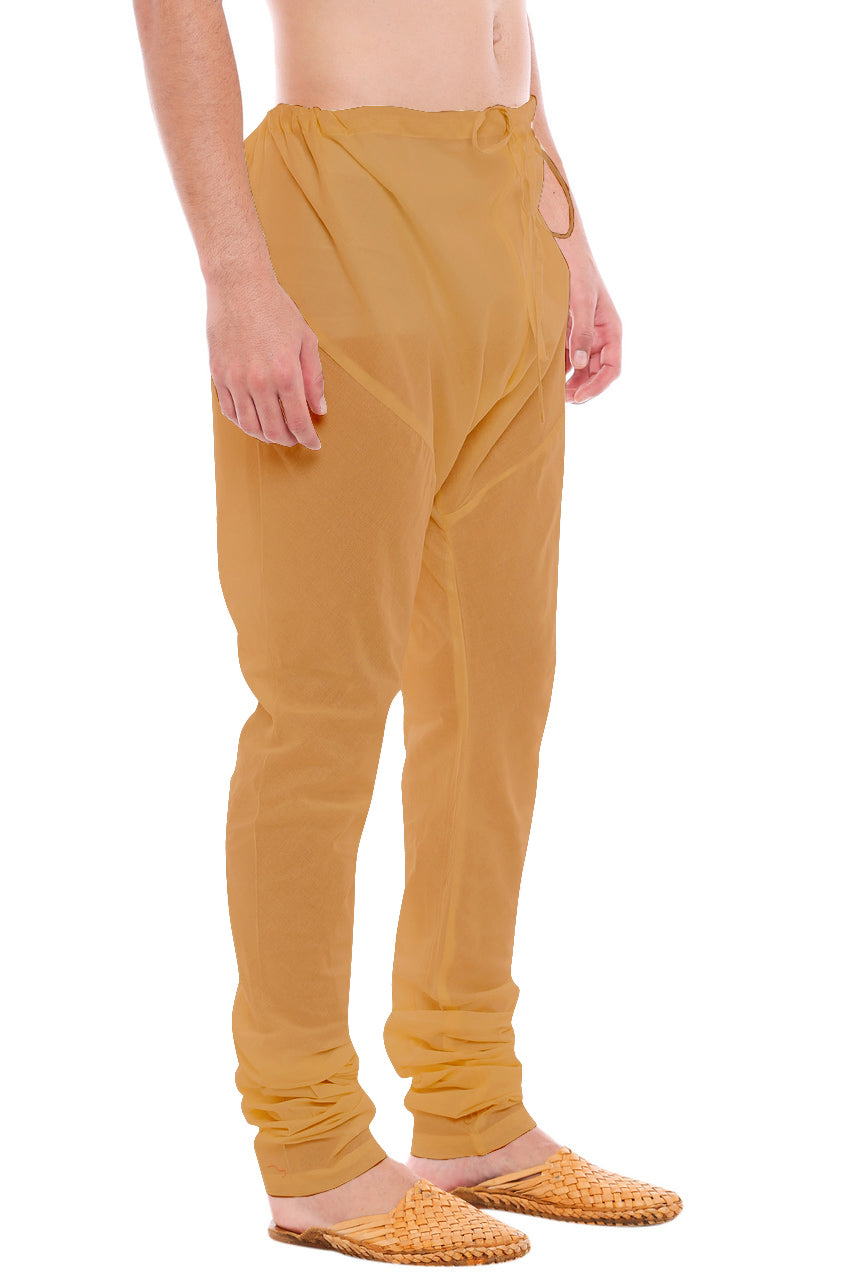 Left profile view of In-Sattva men's gold art silk churidar pants, showing the lustrous art silk finish and gathered ankle fit.