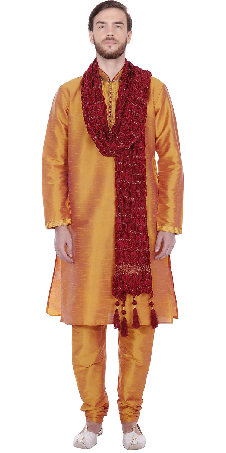 In-Sattva men's gold art silk churidar pants styled with a kurta, showing the coordinated color and gathered ankle fit.