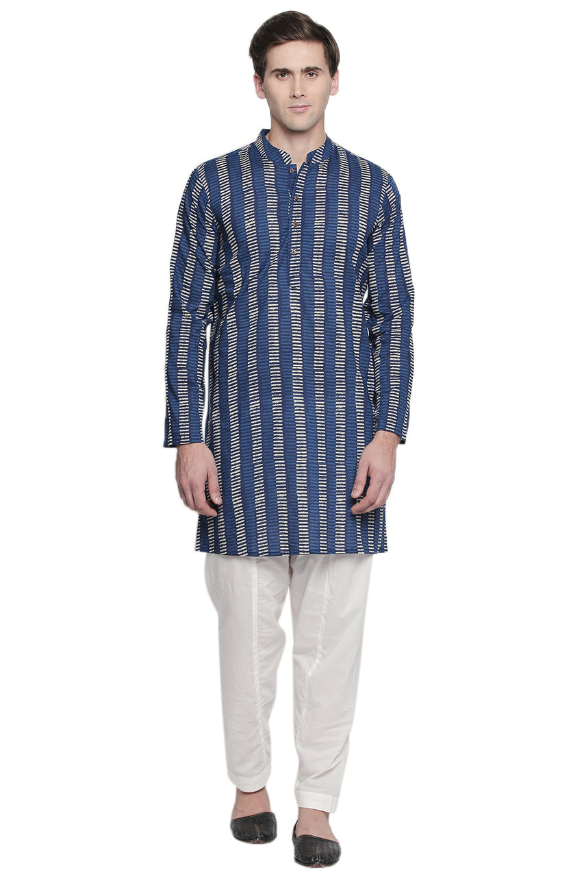 Full-length front view of In-Sattva men's off-white cotton baggy salwar yoga pants, showing the roomy hips and tapered ankles.
