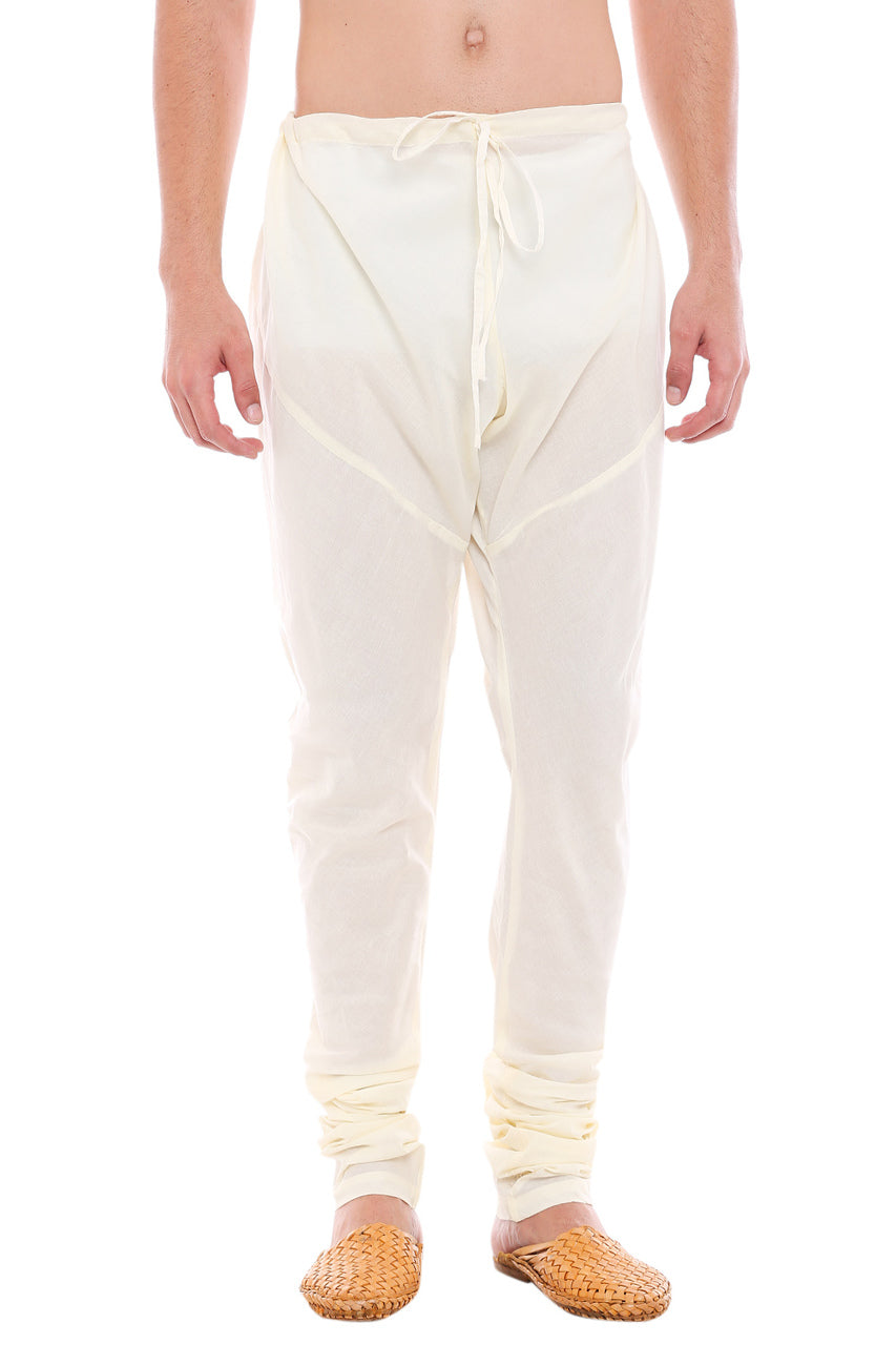 Front view of In-Sattva men's off-white cotton churidar pants, showing the drawstring waist, tapered legs and ankle gathers.