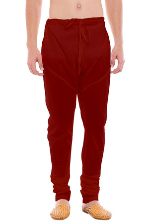 Front view of In-Sattva men's red art silk churidar pants, showing the drawstring waist, tapered legs and ankle gathers.