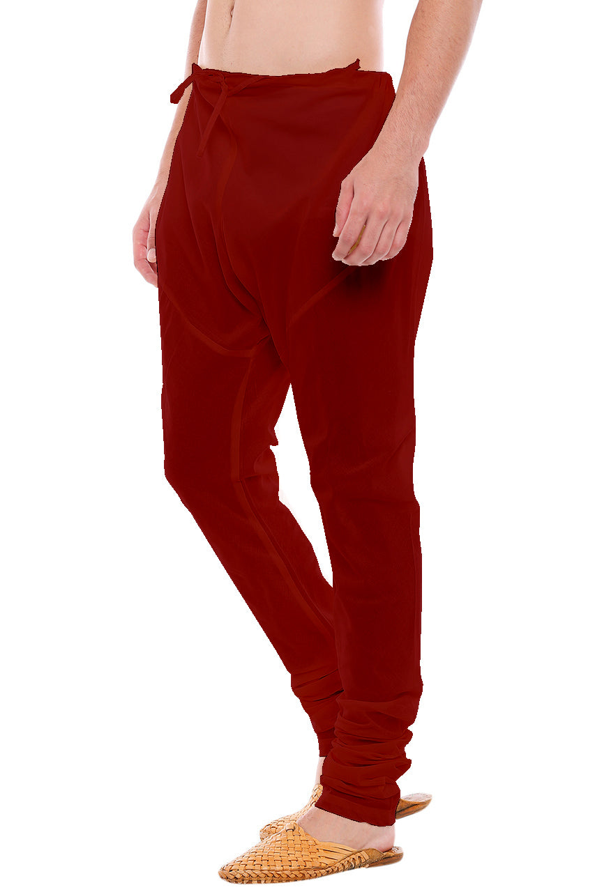 Left profile view of In-Sattva men's red art silk churidar pants, showing the smooth art silk sheen and gathered ankle fit.
