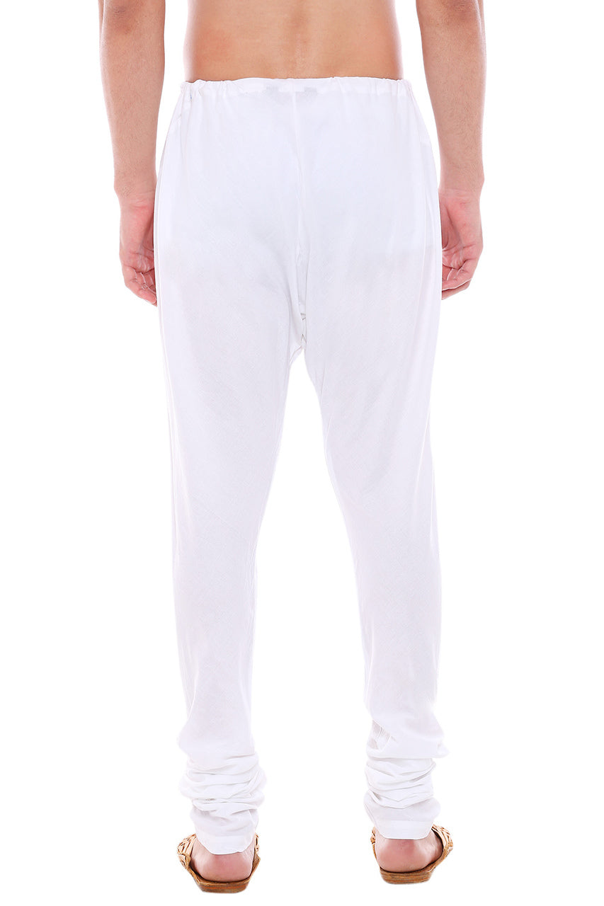 Back view of In-Sattva men's white cotton churidar pants, showing the tapered full-length fit and ankle gathers from the back.