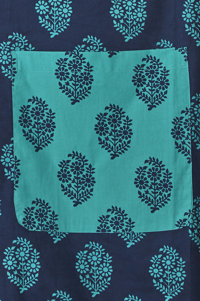 Close-up of the multicolor bohemian print, roomy pocket and frilly hem on an In-Sattva cotton apron