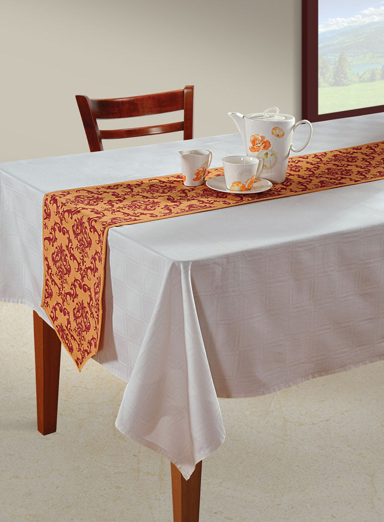 In-Sattva rust bohemian print table runner styled across a white dining table with a tea set