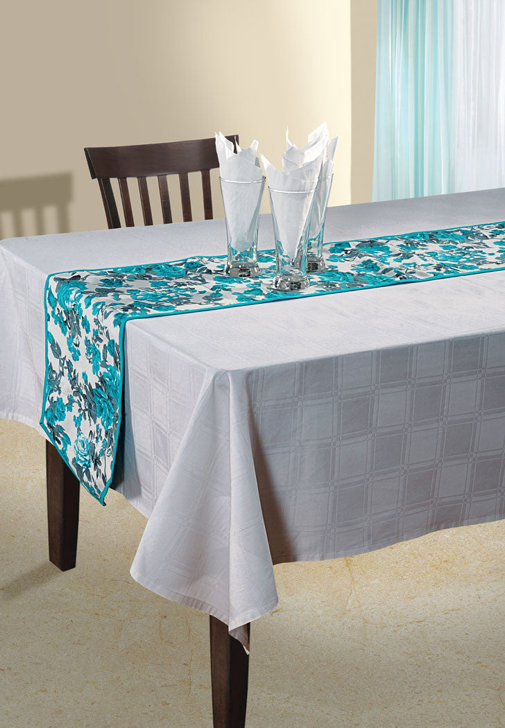 In-Sattva teal bohemian floral print cotton table runner styled on a white dining table with glassware