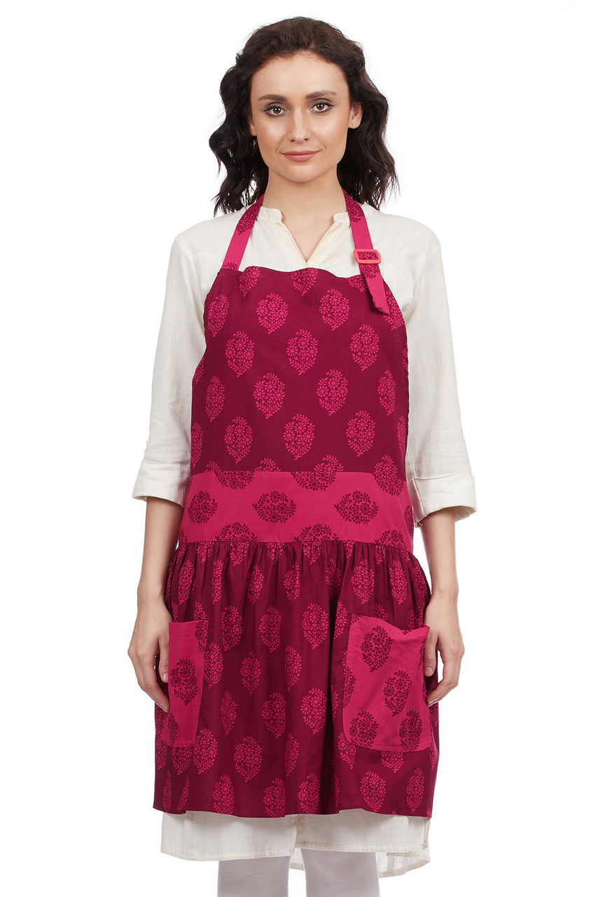 Women's pink 100% cotton bohemian bib apron with roomy pockets and a frilly hem by In-Sattva