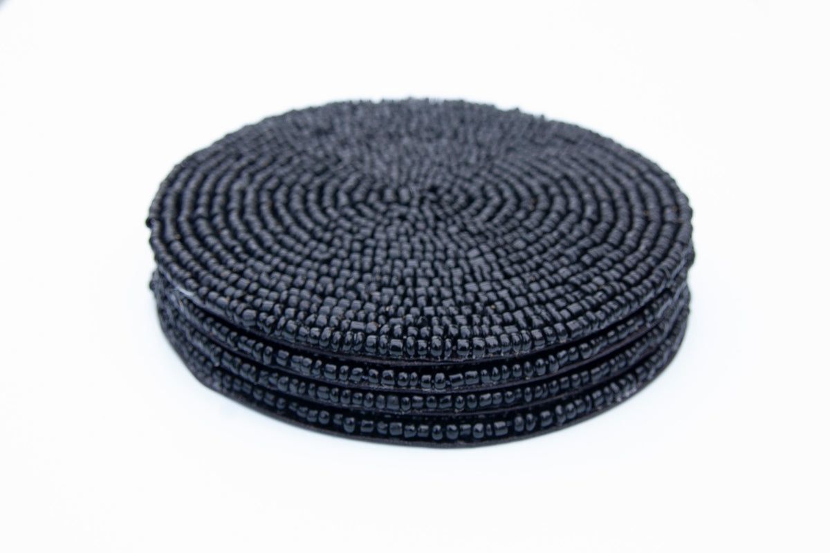Stacked set of Rangeene black handmade glass beaded round coasters