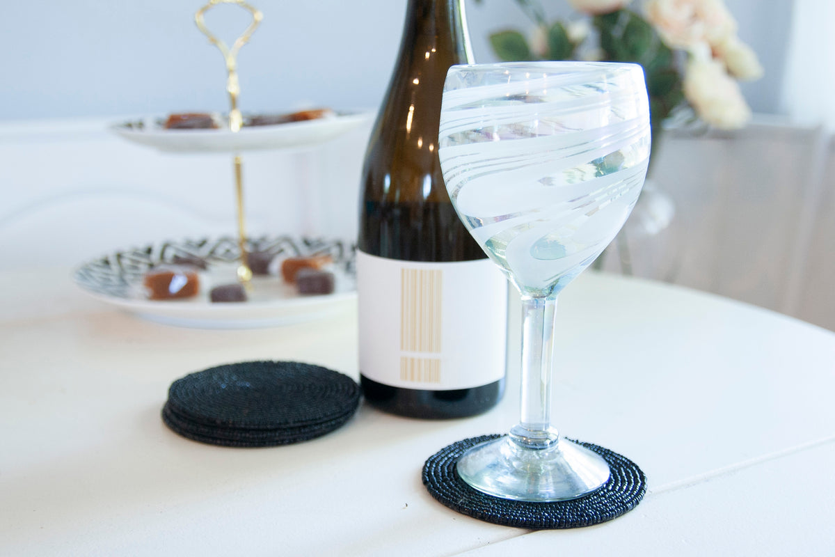 Rangeene black glass beaded round coaster styled beneath a wine glass