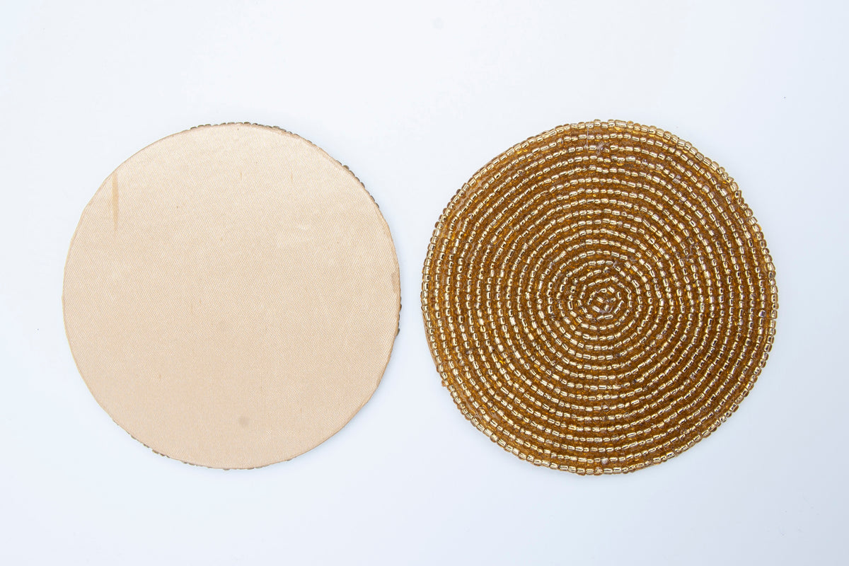 Front and non-slip back of a Rangeene gold glass beaded round coaster