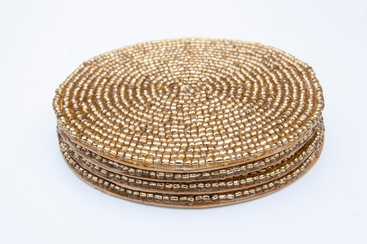 Stacked set of Rangeene gold handmade glass beaded round coasters