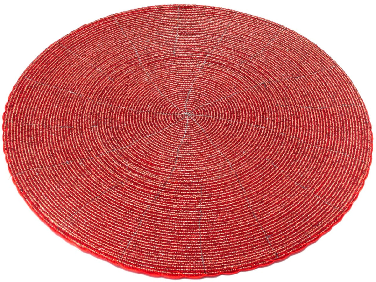 Angled view of a Rangeene red handmade glass beaded round dining placemat