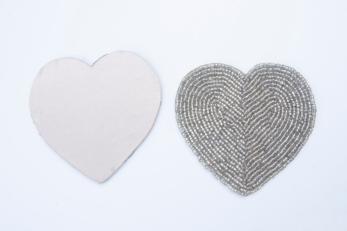 Front and non-slip back of a Rangeene silver glass beaded heart shaped coaster