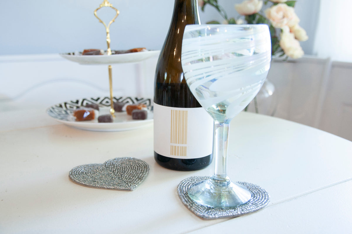 Rangeene silver glass beaded heart shaped coaster styled beneath a wine glass