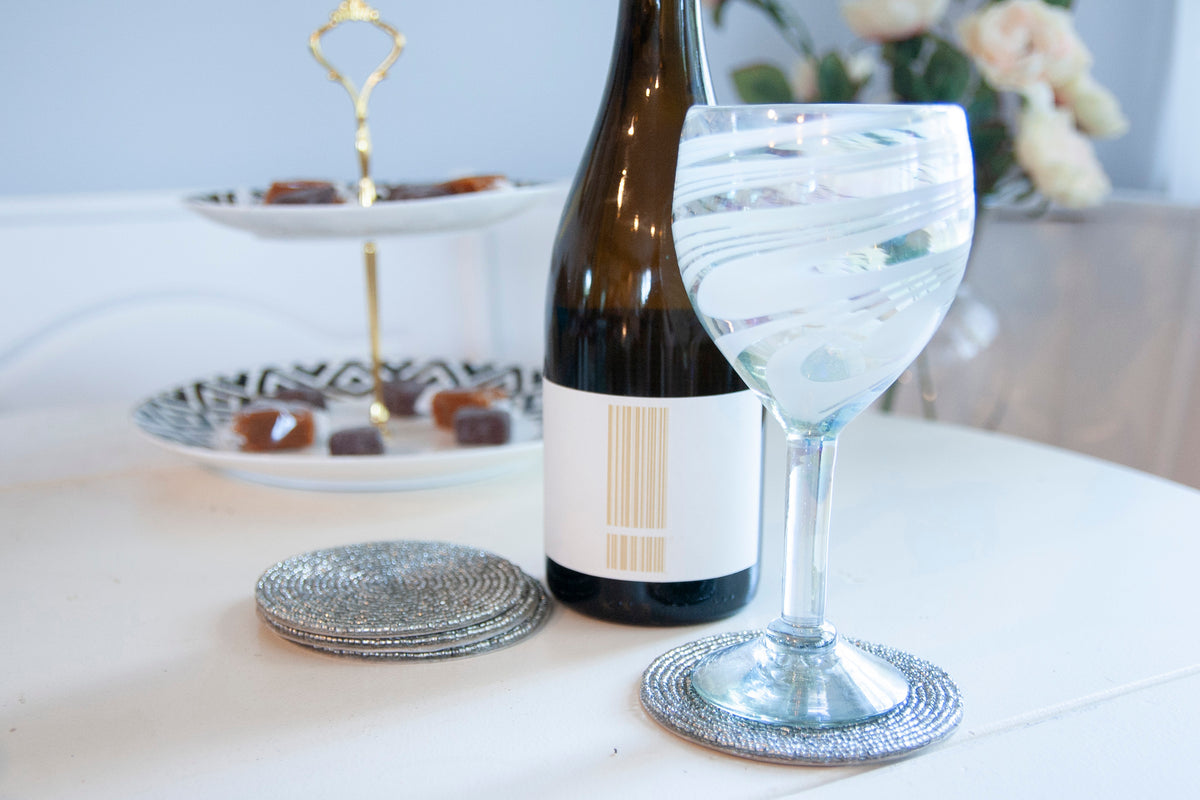 Rangeene silver glass beaded round coaster styled beneath a wine glass