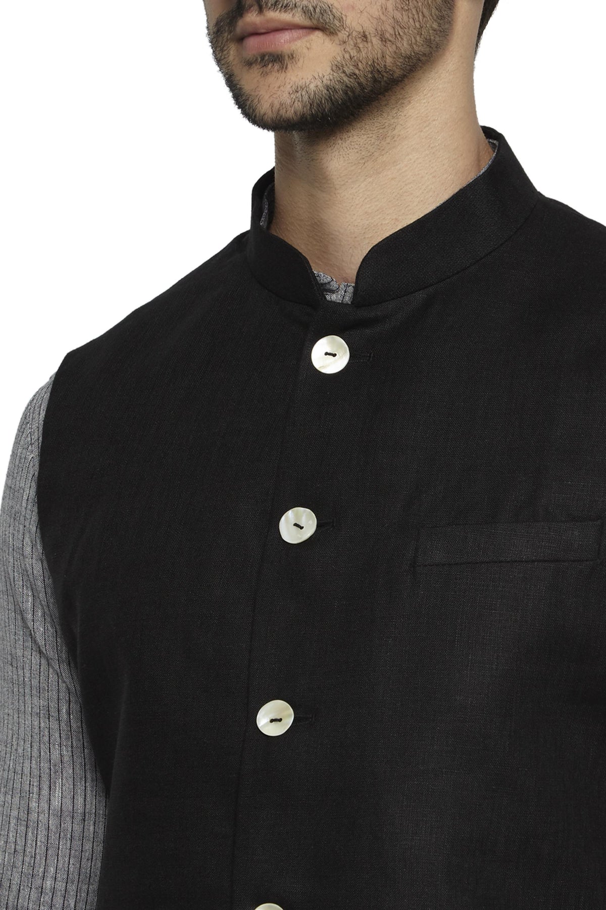 Front pocket close-up of men's black cotton-linen Nehru jacket vest, highlighting premium wedding guest style.