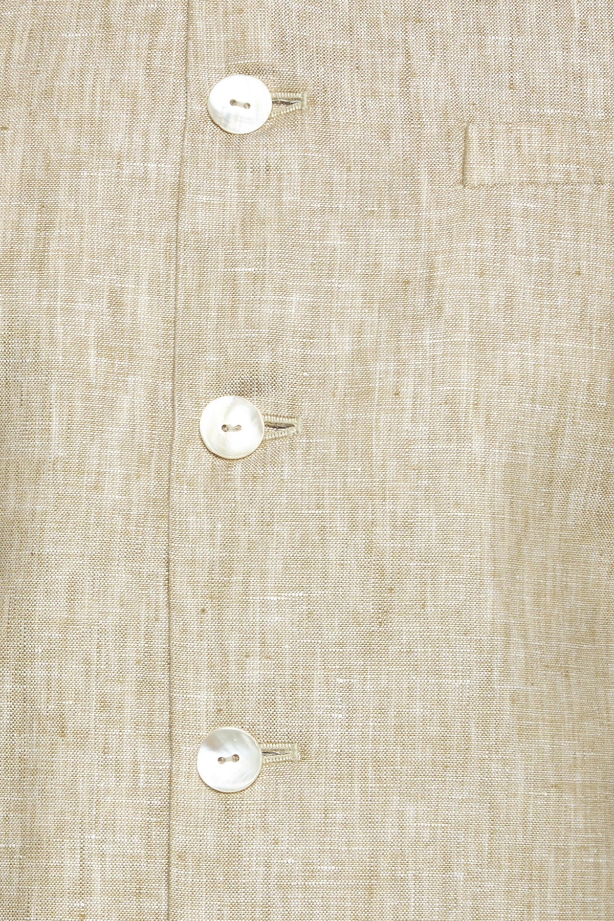 Fabric and stitching close-up of men's light beige Nehru jacket vest, highlighting stylish wedding and special-occasion wear.