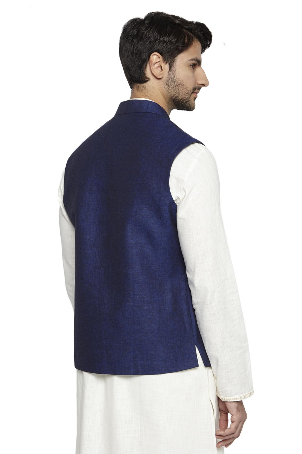 Collar and button close-up of men's navy blue Nehru jacket vest, highlighting a polished festive wedding guest look.