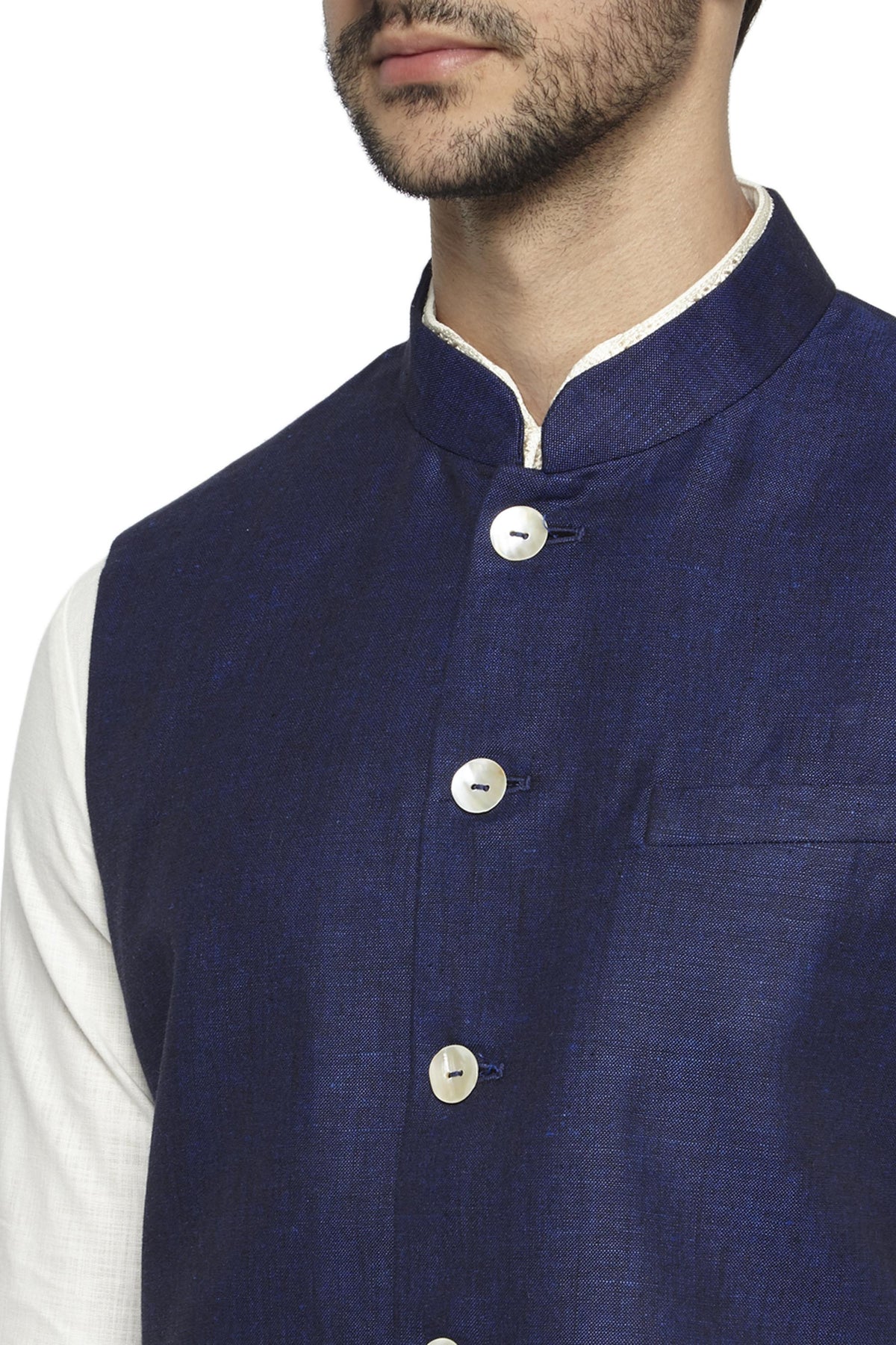 Fabric and stitching close-up of men's navy blue Nehru jacket vest, highlighting a polished festive wedding guest look.