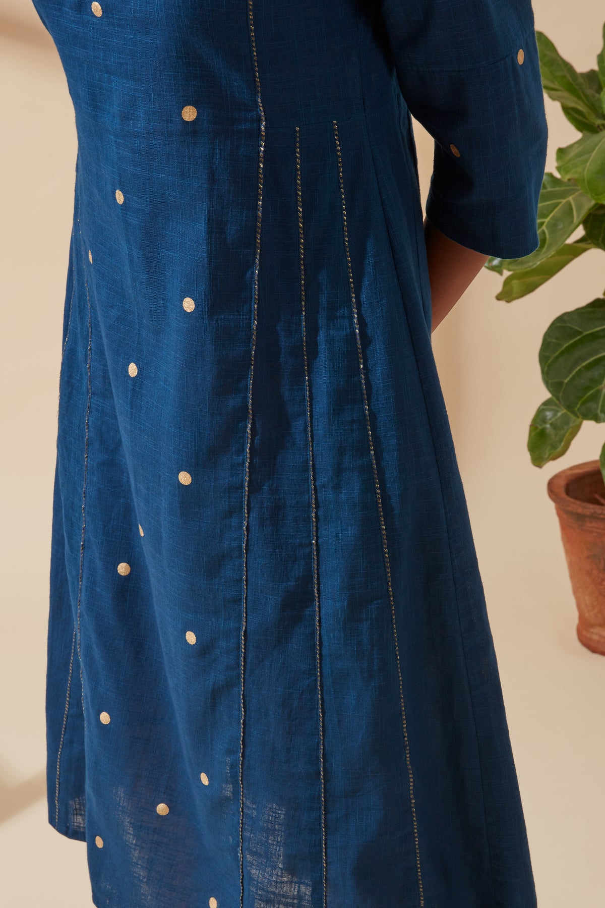 Close-up of Jove Women's Indigo and Gold Bohemian Kurta, highlighting the finely woven Dori embroidery and decorative sleeve detailing.