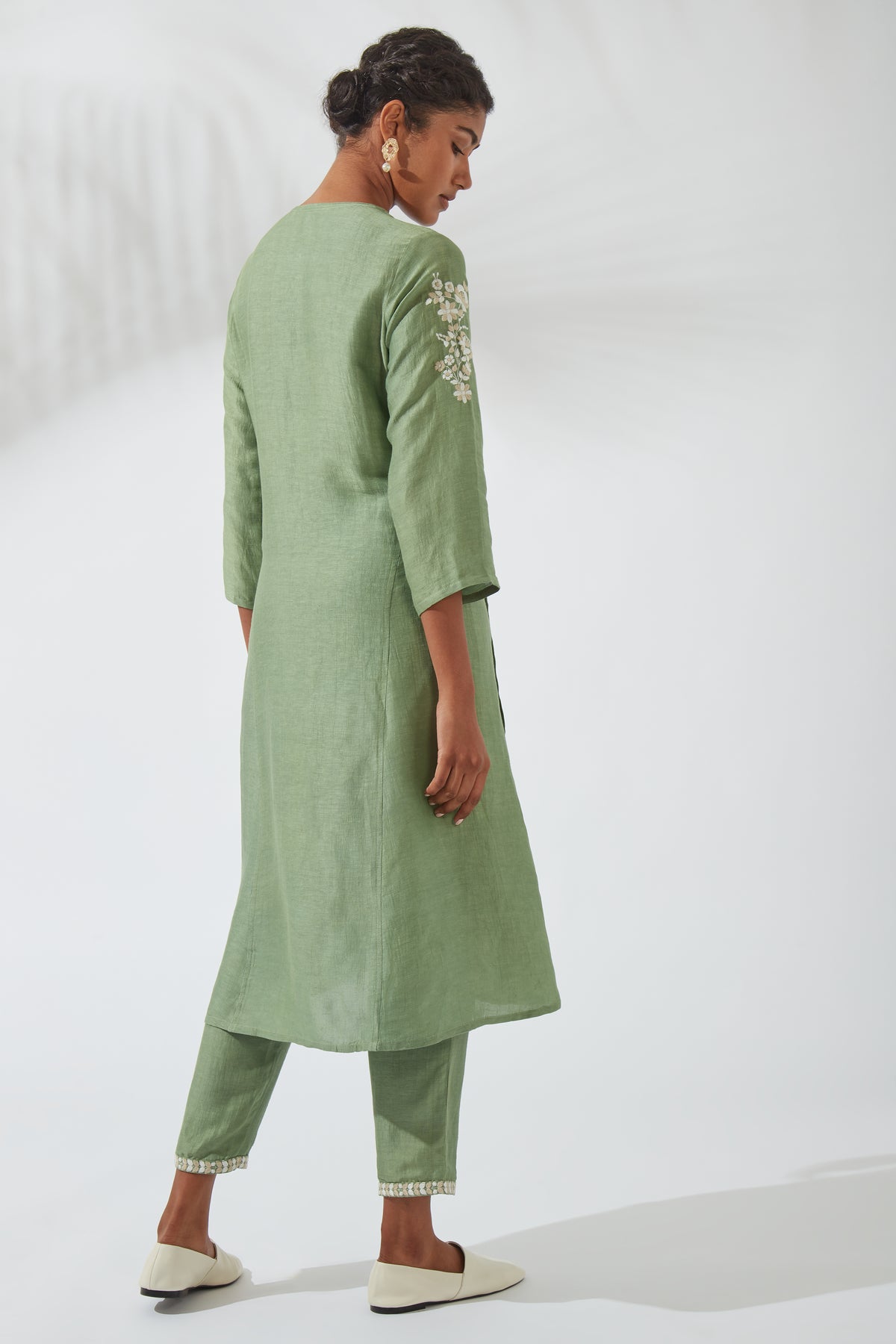 Three-quarter back view of Women's Forest Green Silk Linen Kurta Dress, displaying the straight rear silhouette, flowing hemline, embroidered shoulder detail and three-quarter sleeves.
